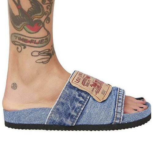 Denim flat slide sandal worn on foot