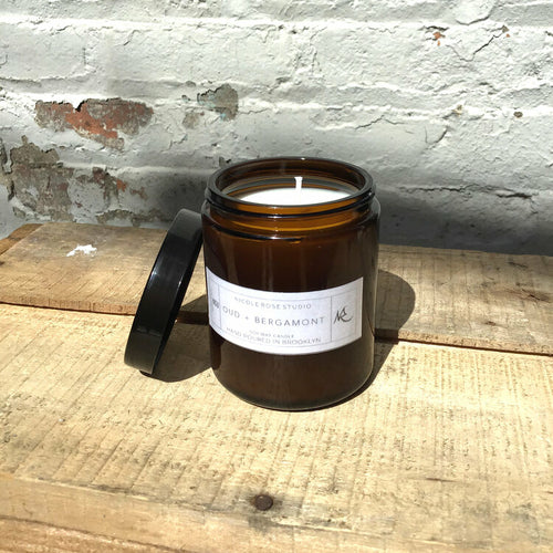 Oud and bergamot soy wax candle, lit