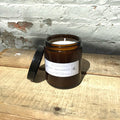 Oud and bergamot soy wax candle, lit