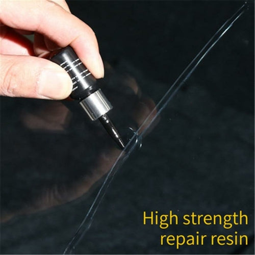 Windshield repair kit in use on crack